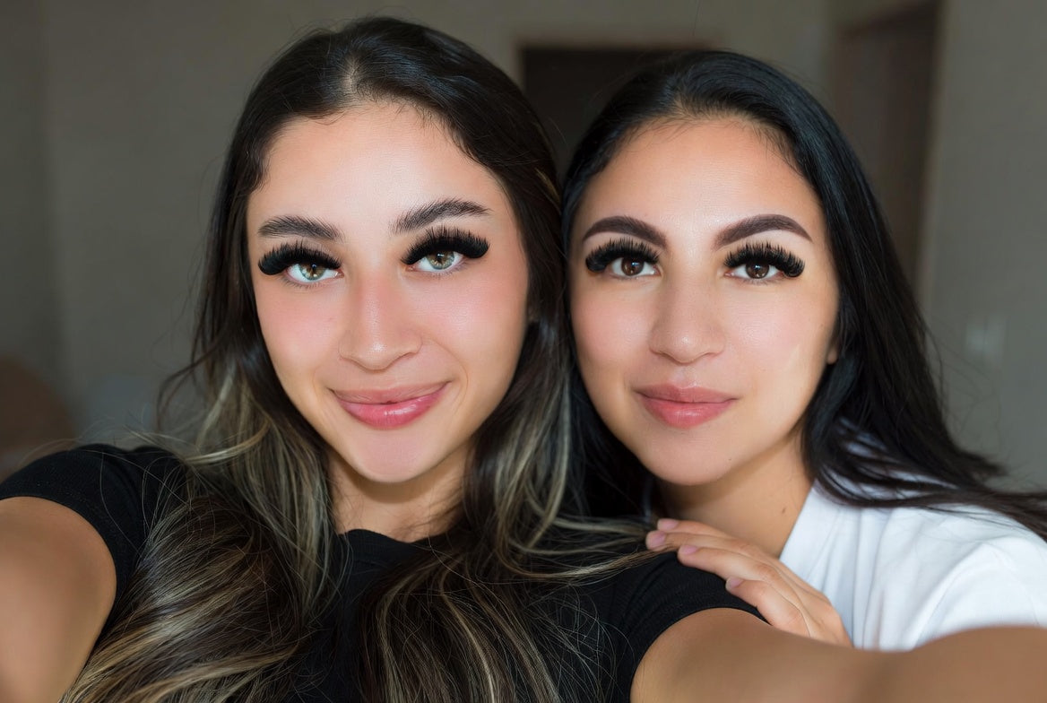 2 women wearing lashes