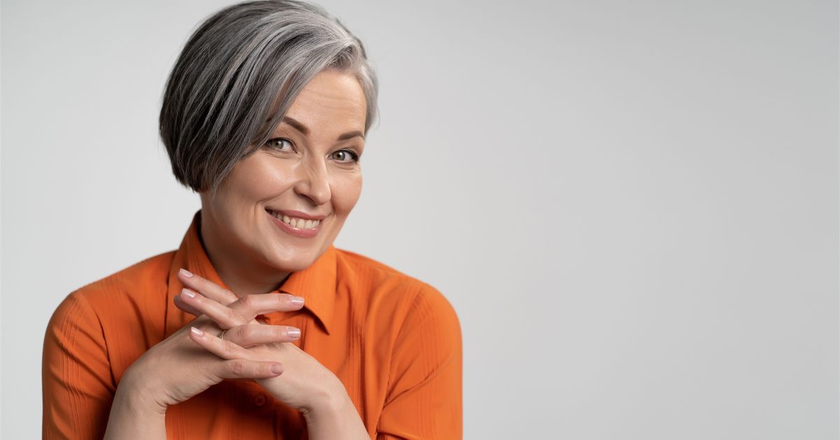 Smiling Matured Woman Wearing an Orange Shirt