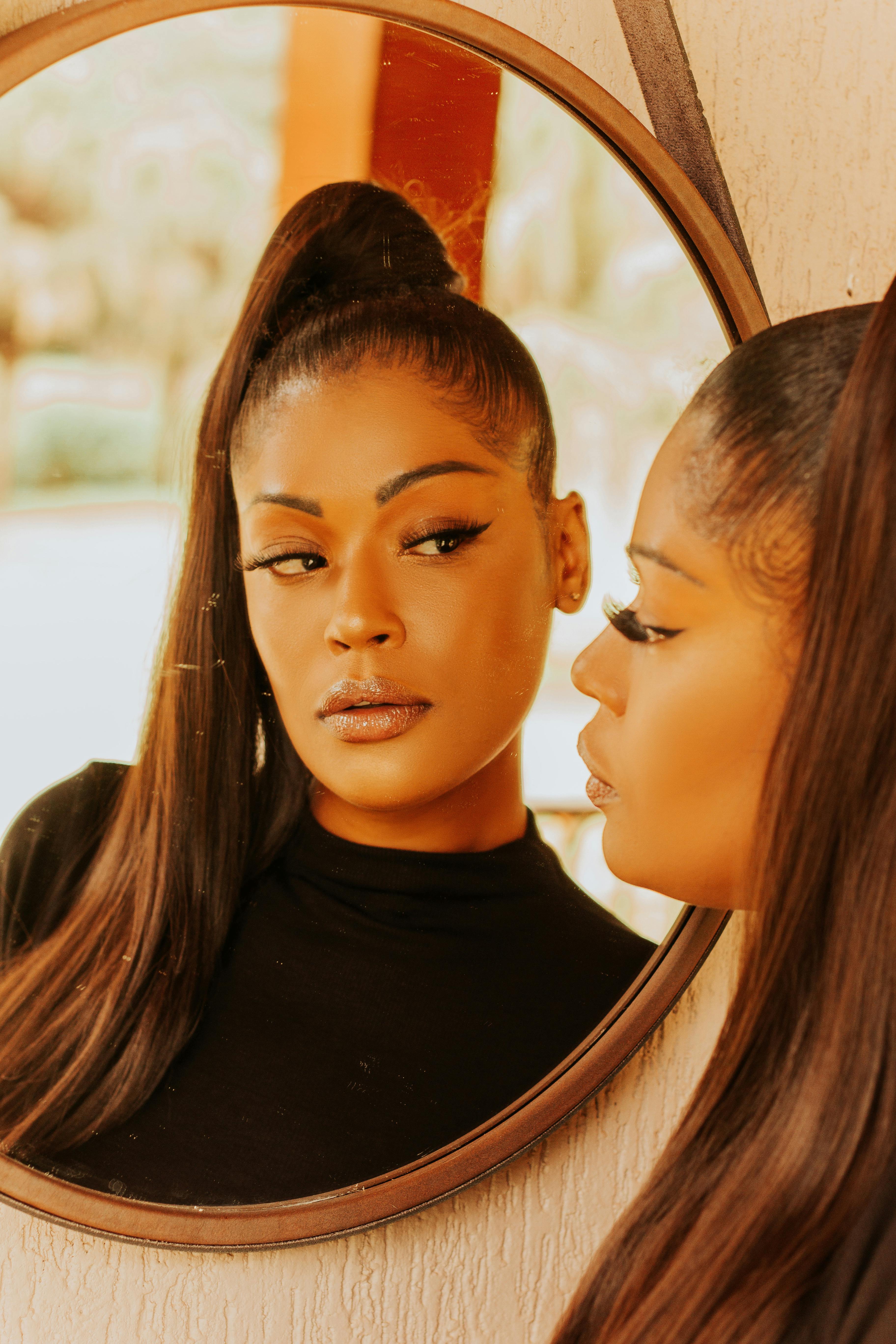 Woman With False Lashes Looking in the Mirror