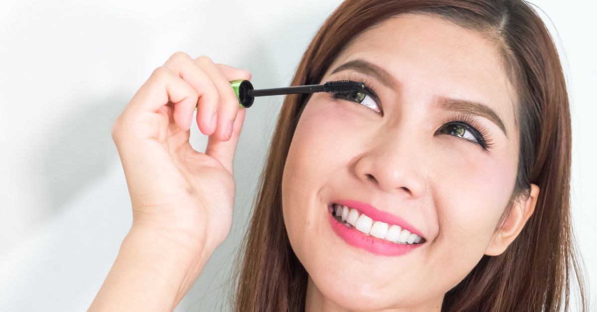 Woman applying mascara on Lashes