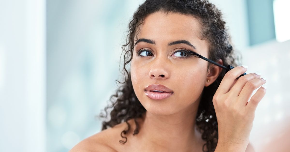 Women brushing Eyelash extensions